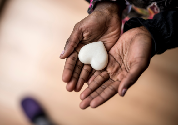 image of hands holding heart-shaped object